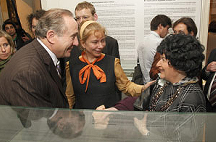 A guest at the exhibit opening tells Michael Reagan how she escaped East Berlin.